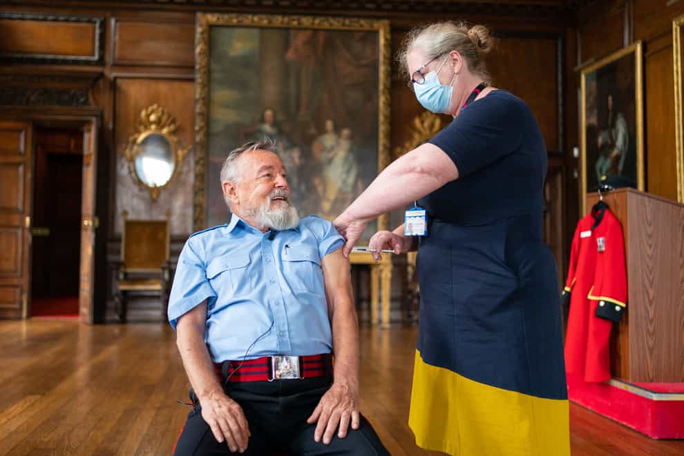 Chelsea Pensioner John Byrne receives a Covid-19 booster vaccination from deputy chief Nurse Vanessa Sloane at the Royal Hospital Chelsea in London (Dominic Lipinski/PA)