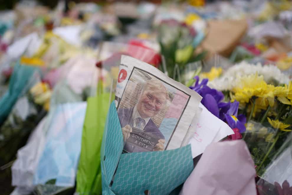 An edition of the Southend Echo tucked into one of the floral tributes left outside the Belfairs Methodist Church in Leigh-on-Sea, Essex, where Conservative MP Sir David Amess was killed on Friday (Joe Giddens/ PA)