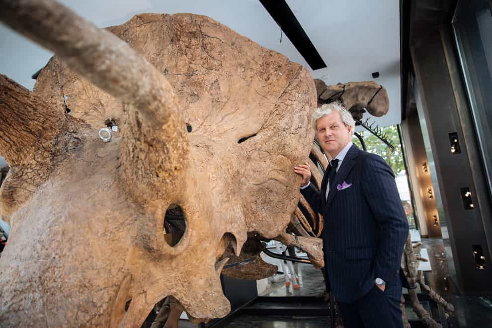 Auctioneer Alexandre Giquello poses in front of Big John (Lewis Joly/AP)