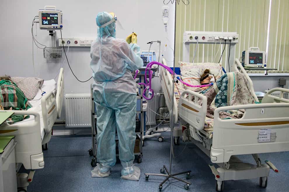A medical worker treats a patient on an intensive care unit at a Russian hospital (Roman Yarovitcyn/AP)