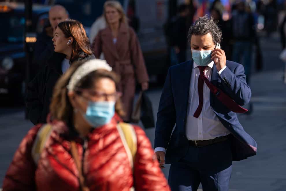 People wearing face masks on Oxford Street in central London (Dominic Lipinski/PA)