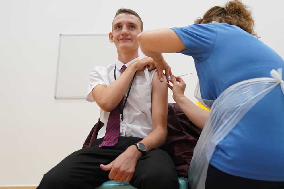 Jack Lane, 14, receives a Covid-19 vaccination at Belfairs Academy in Leigh-on-Sea, Essex (Gareth Fuller/PA)
