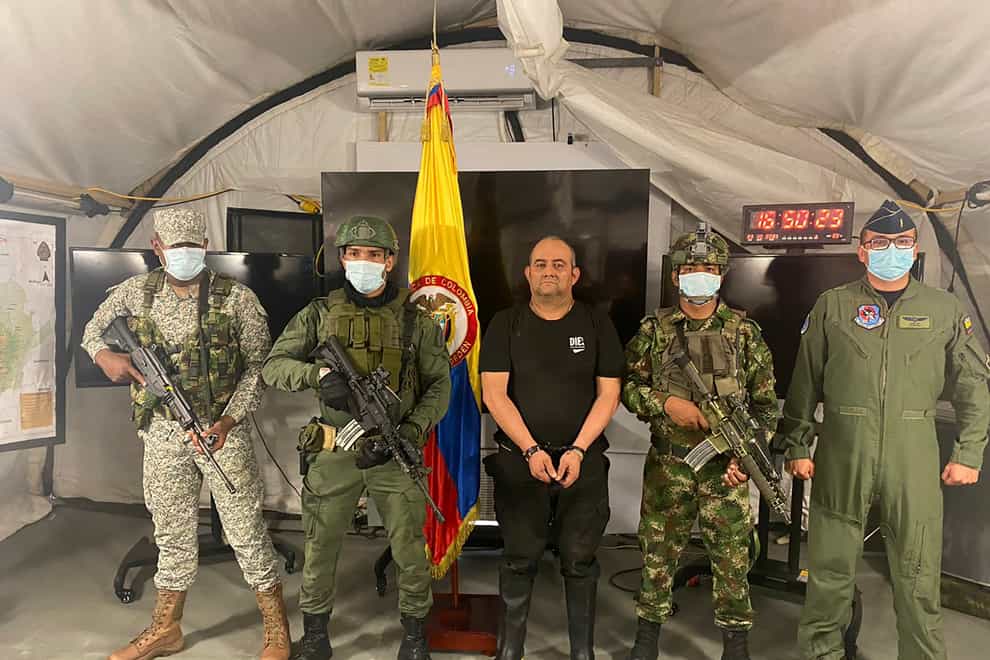 One of Colombia’s most wanted drug traffickers, Dairo Antonio Usuga, alias “Otoniel,” leader of the violent Clan del Golfo cartel, is presented to the media while flanked by armed soldiers at a military base in Necocli (Colombian presidential press office/AP)