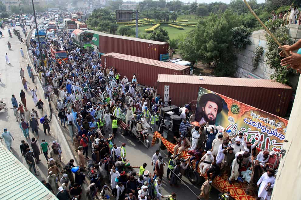Supporters of banned radical Islamist party Tehreek-e-Labiak Pakistan head for Islamabad during a protest march on the outskirts of Lahore (KM Chaudary/AP)