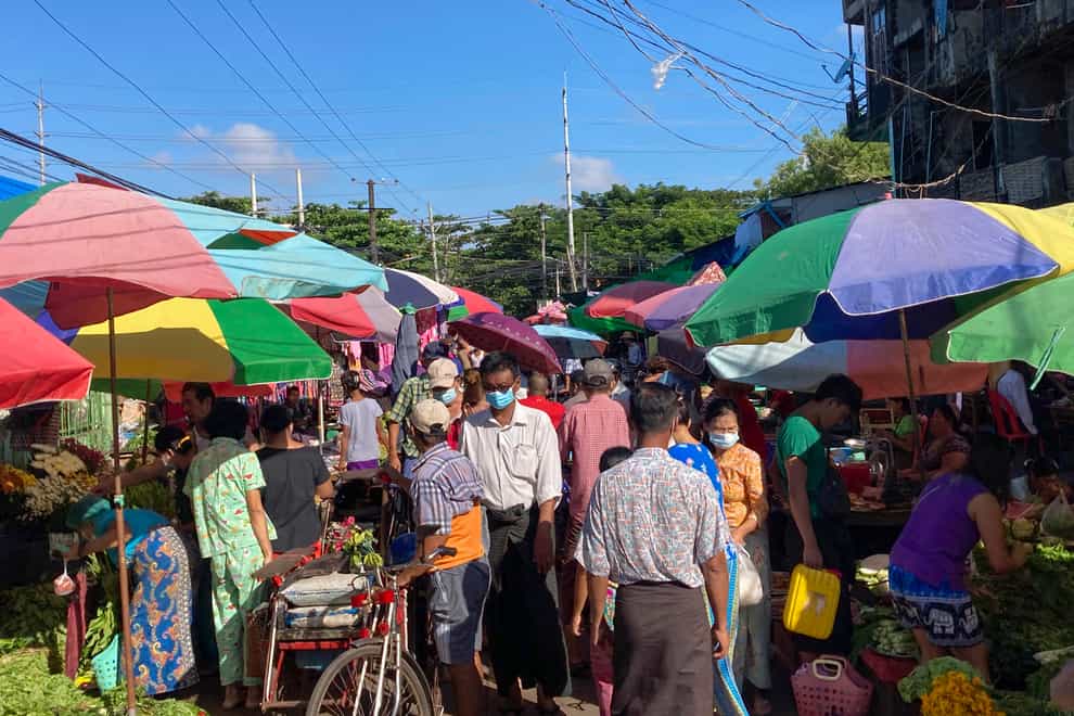 People walk through a crowded street market in Yangon, Myanmar (AP)