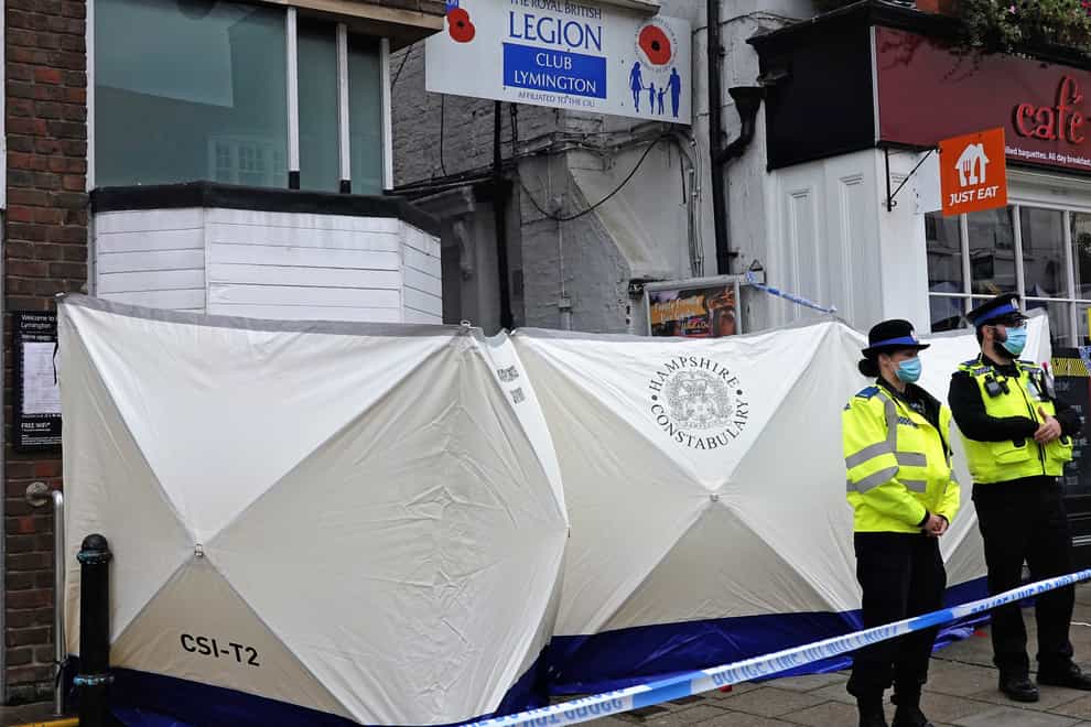Police at the scene outside the Royal British Legion on High Street in Lymington, Hampshire, where two men and a woman were found with stab wounds on Friday (Brian Farmer/PA)