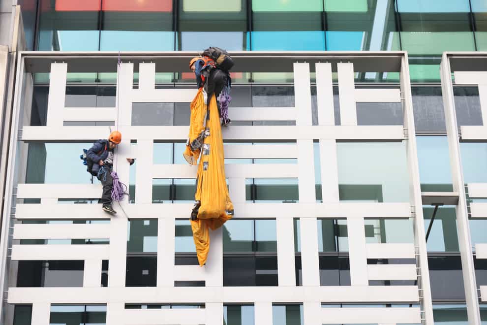 Activists from Animal Rebellion after scaling the outside of the Defra building in Westminster (James Manning/PA)
