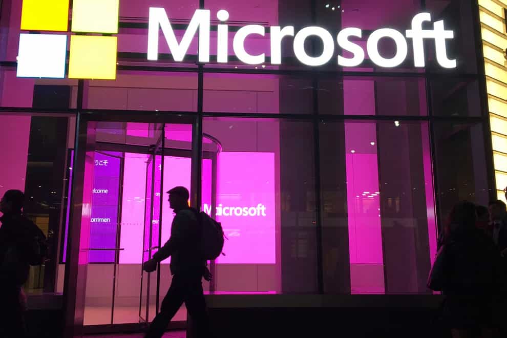 People walk past a Microsoft office in New York (Swayne B Hall/AP)