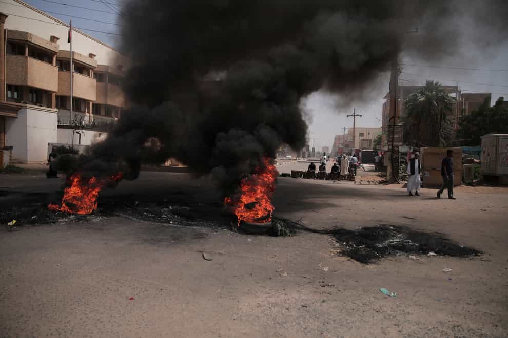 People burn tyres during a protest a day after the military seized power in Khartoum, Sudan (Marwan Ali/AP)