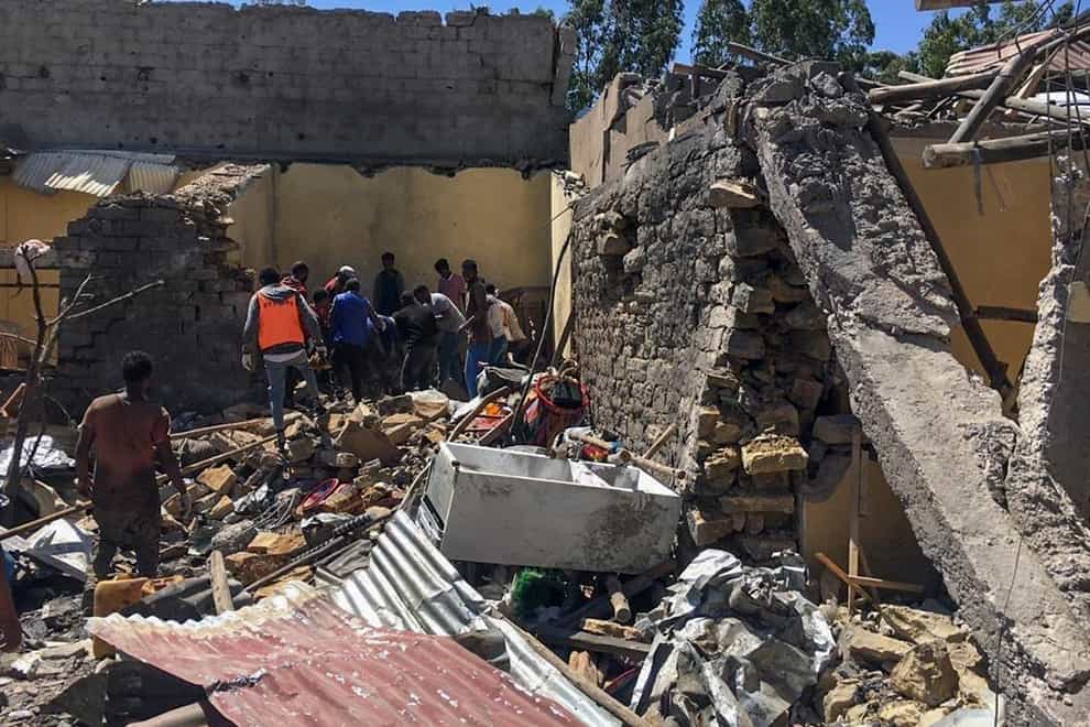 Residents sift through rubble from a destroyed building in the Tigray region of northern Ethiopia (AP Photo)