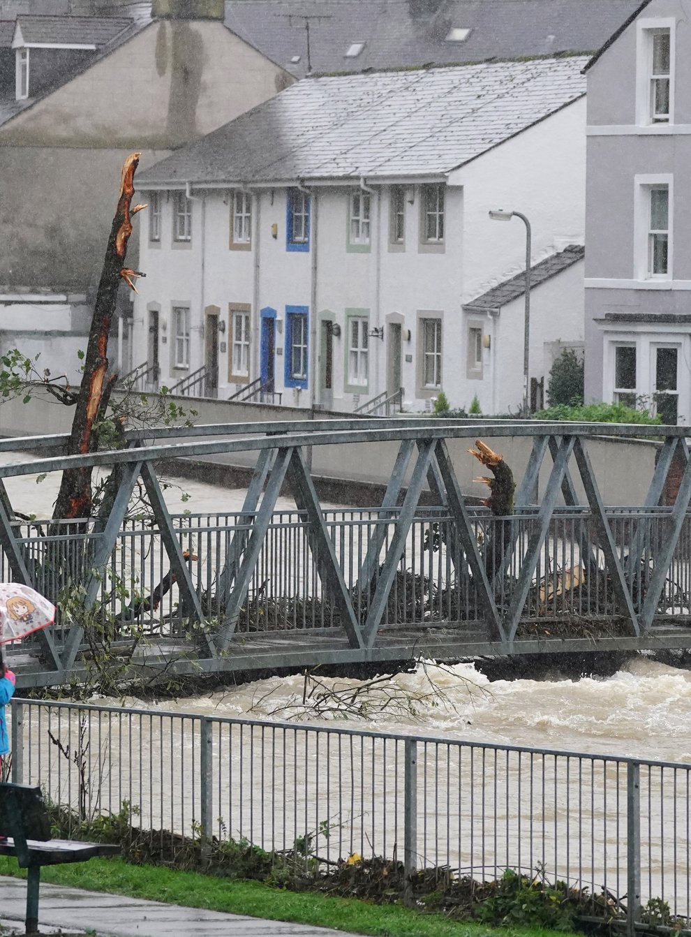 Residents watch rising water levels in Cockermouth (Owen Humphreys/PA)