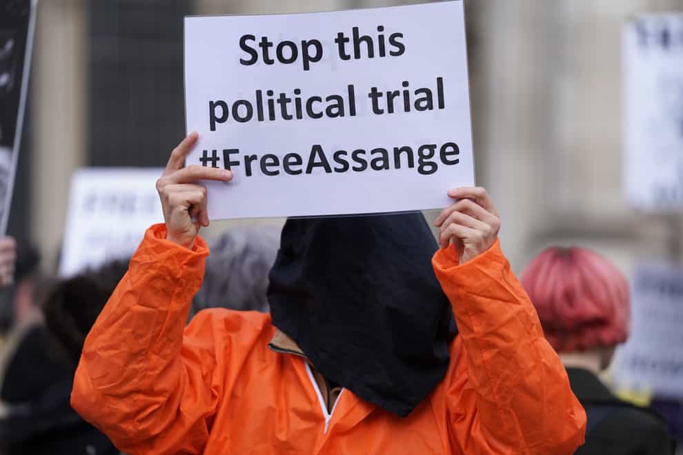 A protester outside the High Court in London, ahead of a hearing in the US government’s legal challenge over a judge’s decision not to extradite Wikileaks founder Julian Assange (Kirsty O’Connor/PA)