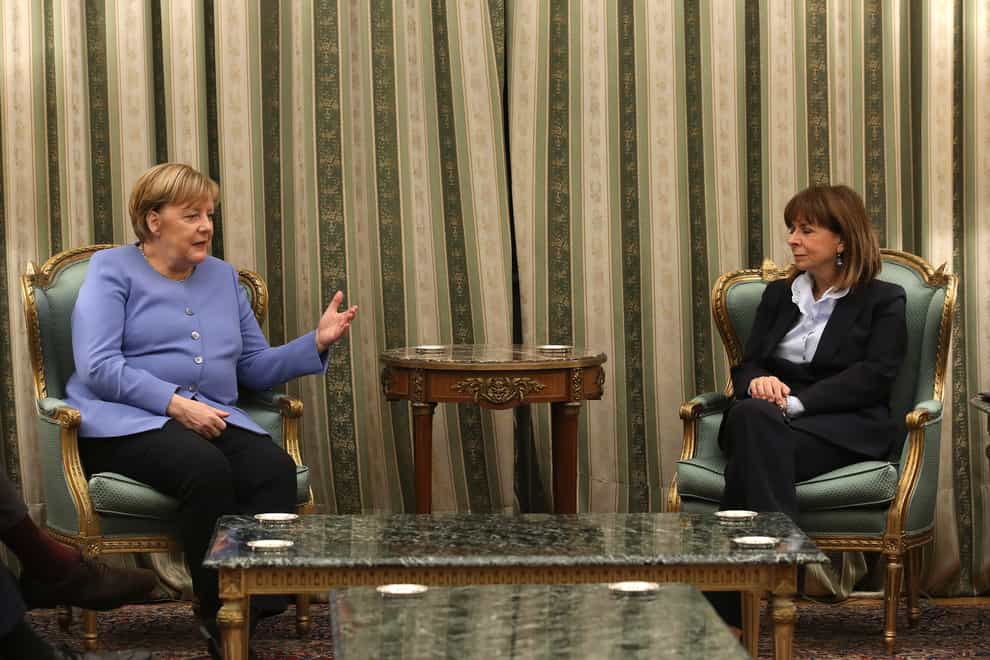 Greece’s President Katerina Sakellaropoulou, right, and Germany’s Chancellor Angela Merkel talk during their meeting at Presidential Palace in Athens (AP Photo/Yorgos Karahalis)