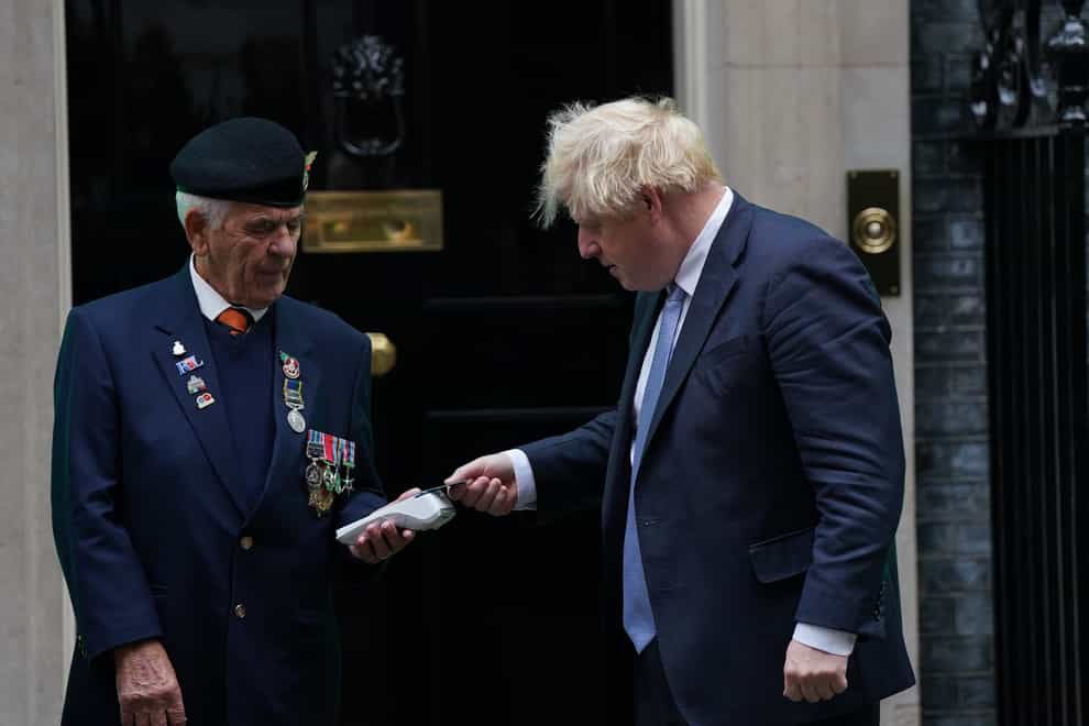 Prime Minister Boris Johnson using the card machine to donate to the poppy appeal (Steve Parsons/PA)