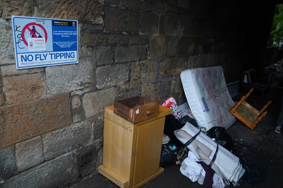 Rubish beside a no fly tipping sign in Glasgow (Andrew Milligan/PA)