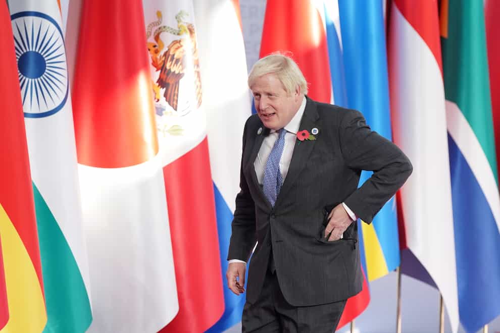 Prime Minister Boris Johnson arrives to be welcomed by Italian Prime Minister Mario Draghi to the G20 summit in Rome, Italy (Stefan Rousseau/PA)