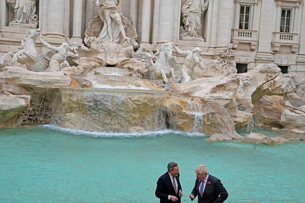British Prime Minister Boris Johnson, right, speaks with Italy’s Prime Minister Mario Draghi in front of the Trevi Fountain during an event for the G20 summit in Rome, Sunday, Oct. 31, 2021. The two-day Group of 20 summit concludes on Sunday, the first in-person gathering of leaders of the world’s biggest economies since the COVID-19 pandemic started. (AP Photo/Gregorio Borgia)