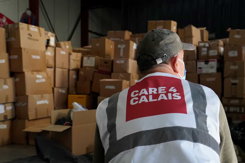 Volunteers go through donated clothes at the Care4Calais warehouse in Calais (Gareth Fuller/PA)