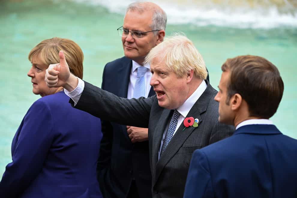 Boris Johnson gives a thumbs-up as he stands with French President Emmanuel Macron (right) as they join G20 leaders during a visit to the Trevi fountain in Rome (Jeff J Mitchell/PA)