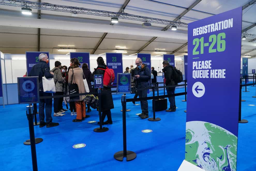 Delegates pick up their accreditation at the Scottish Event Campus ahead of the Cop26 summit in Glasgow (Andrew Milligan/PA)