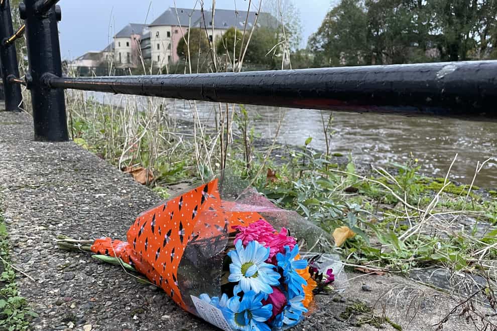 Flowers left by the river Cleddau in Haverfordwest where three people died (Bronwen Weatherby/PA)