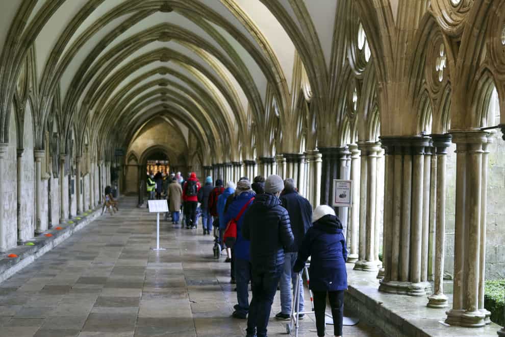 People queue outside Salisbury Cathedral, Wiltshire, to receive an injection of the Pfizer coronavirus vaccine (Steve Parsons/PA)