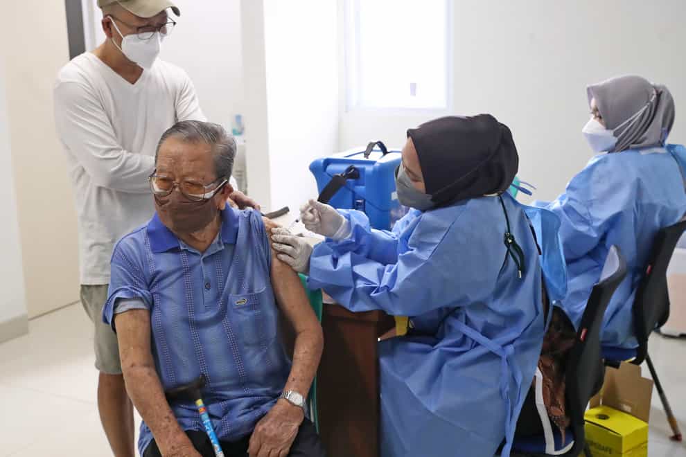 An elderly man receives a Covid-19 vaccine during a vaccination campaign at a community health centre in Tangerang on the outskirts of Jakarta, Indonesia (Tatan Syuflana/AP)