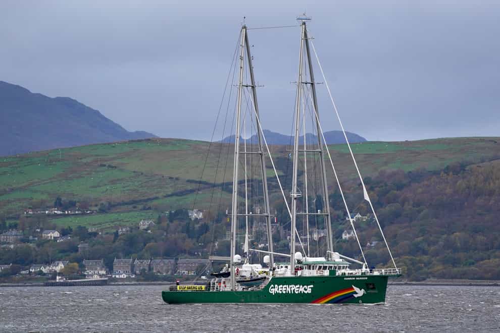 The Greenpeace ship Rainbow Warrior makes its way up the River Clyde, carrying four young climate activists to the Cop26 summit in Glasgow (Andrew Milligan/PA)