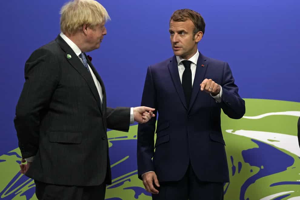 Prime Minister Boris Johnson greets French President Emmanuel Macron at the Cop26 summit in Glasgow (PA)