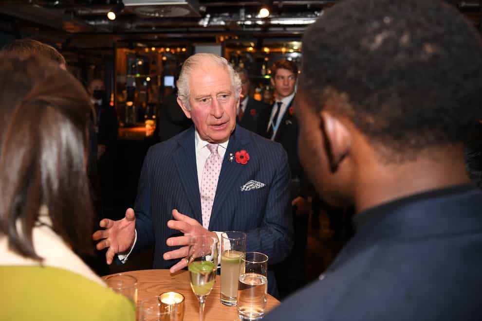 The Prince of Wales speaks with guests at the Clydeside Distillery (PA)