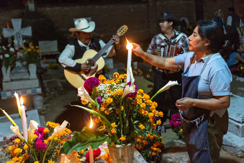Mariachi bands will often play by the graves (Alamy/PA)