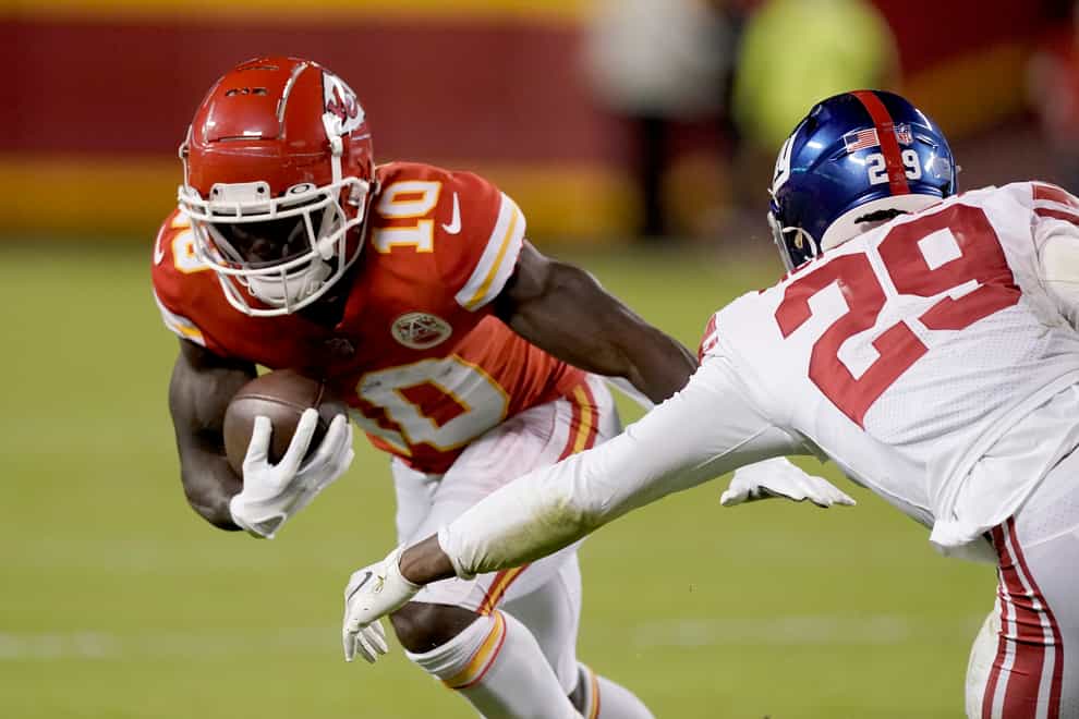 Kansas City Chiefs wide receiver Tyreek Hill (10) runs with the ball after catching a pass as New York Giants safety Xavier McKinney (29) defends (Charlie Riedel/AP)