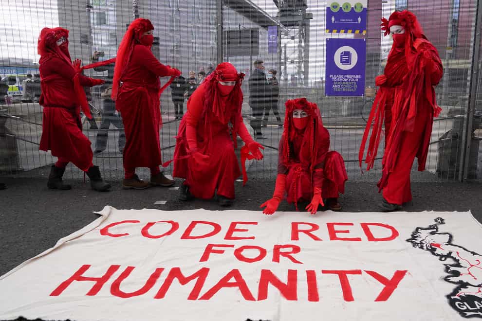 Members of the Red Rebel Brigade stage a protest outside the Cop26 summit in Glasgow (Andrew Milligan/PA News)