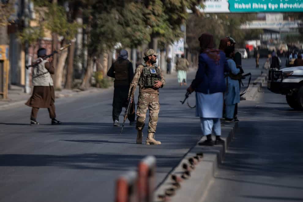Taliban fighters block roads following the attack (Ahmad Halabisaz/AP)