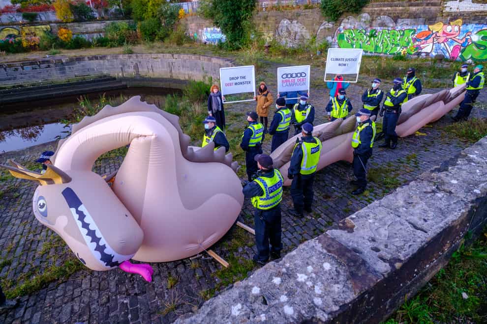 Police officers guard the inflatable Loch Ness Monster (Jess Hurd/PA)