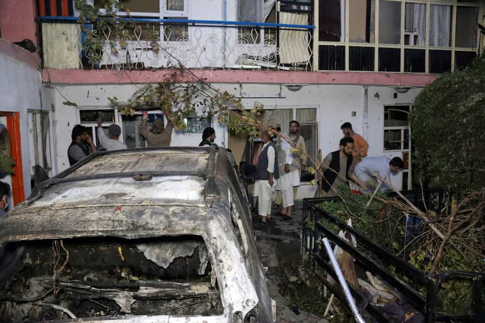 Afghans inspect damage of Ahmadi family house (Khwaja Tawfiq Sediqi/AP)