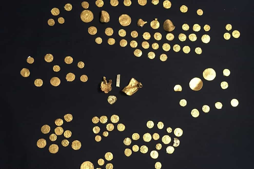 Gold coins, along with four other gold objects, unearthed by metal detectorists which is the largest hoard of Anglo-Saxon gold coins to be discovered in England to date (British Museum/PA)