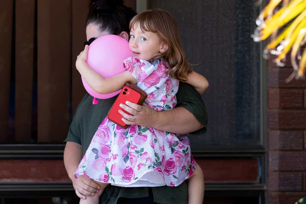 Cleo Smith is carried by her mother Ellie Smith (Richard Wainwright/AAP/AP)