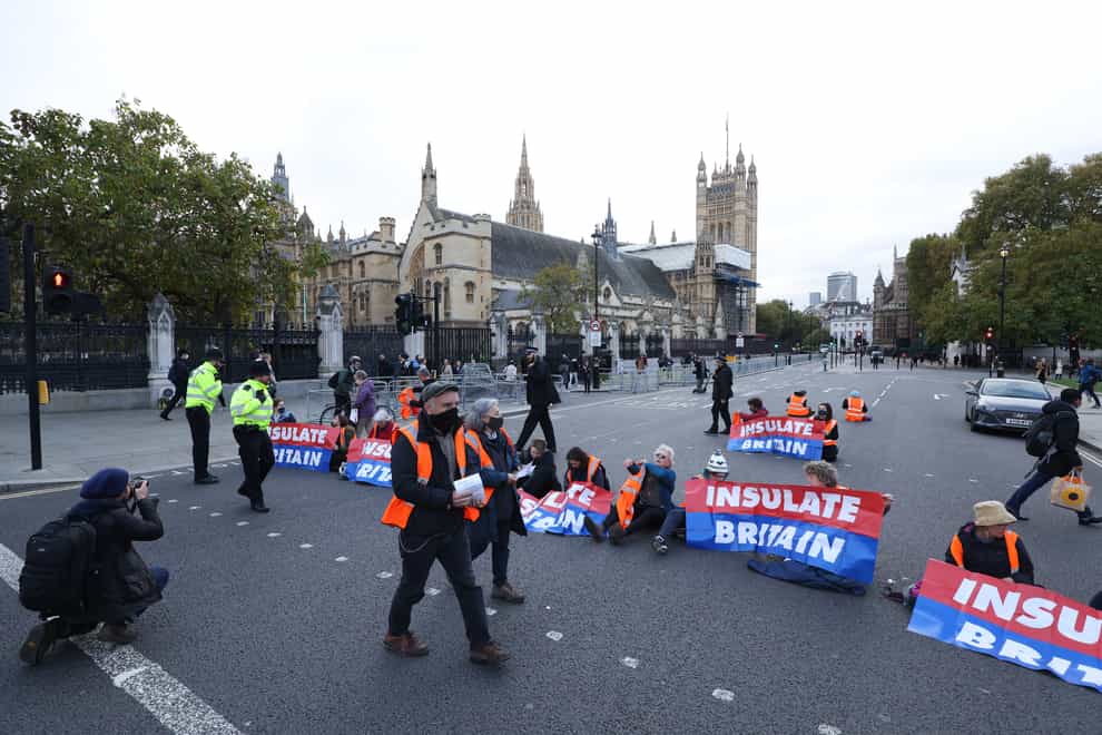 Protesters from Insulate Britain block the road in Parliament Square, central London. (James Manning/PA)
