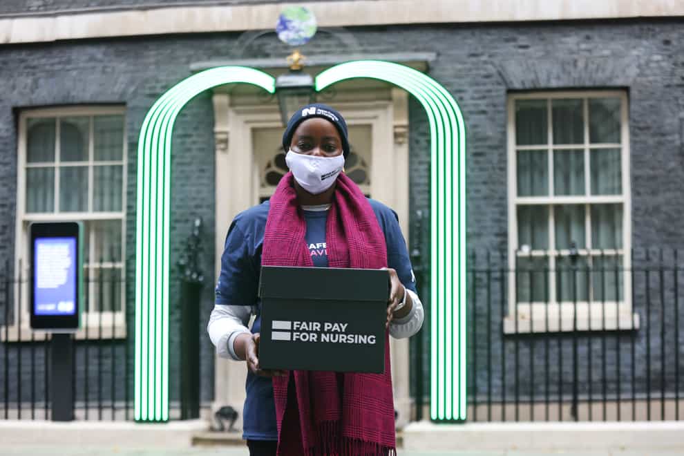Temitope Soile, an NHS staff member from the Royal College of Nursing, outside 10 Downing Street as the petition was handed in (James Manning/PA)