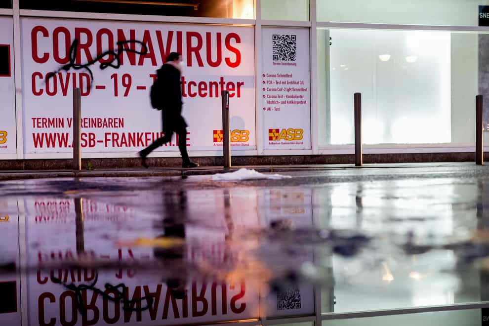 A woman walks past an abandoned coronavirus test centre in Frankfurt, Germany (Michael Probst/AP)