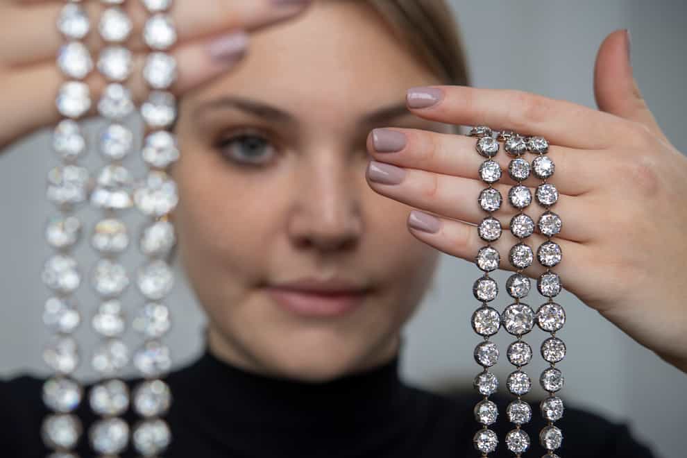 A Christie’s employee displays a pair of diamond bracelets, with approximately 140 to 150 carats and owned by Queen Marie-Antoinette of France, in silver and yellow gold, circa 1776, during a preview at the Christie’s, in Geneva, Switzerland (Martial Trezzini/Keystone via AP)