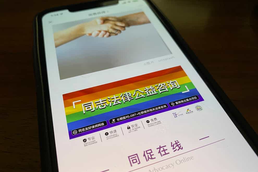 An online post about the work of the LGBT Rights Advocacy Group with a link to their social media account Queer Advocacy Online is displayed on a phone in Beijing (AP)
