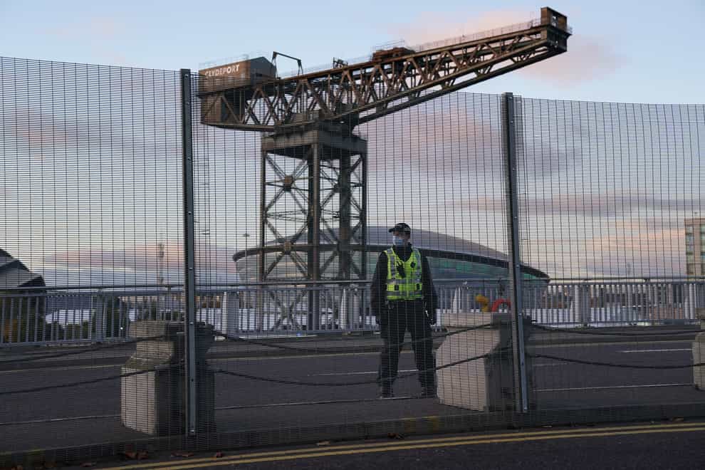 A police officer by the perimeter security fence of the Scottish Event Campus (SEC) in Glasgow (Andrew Milligan/PA)