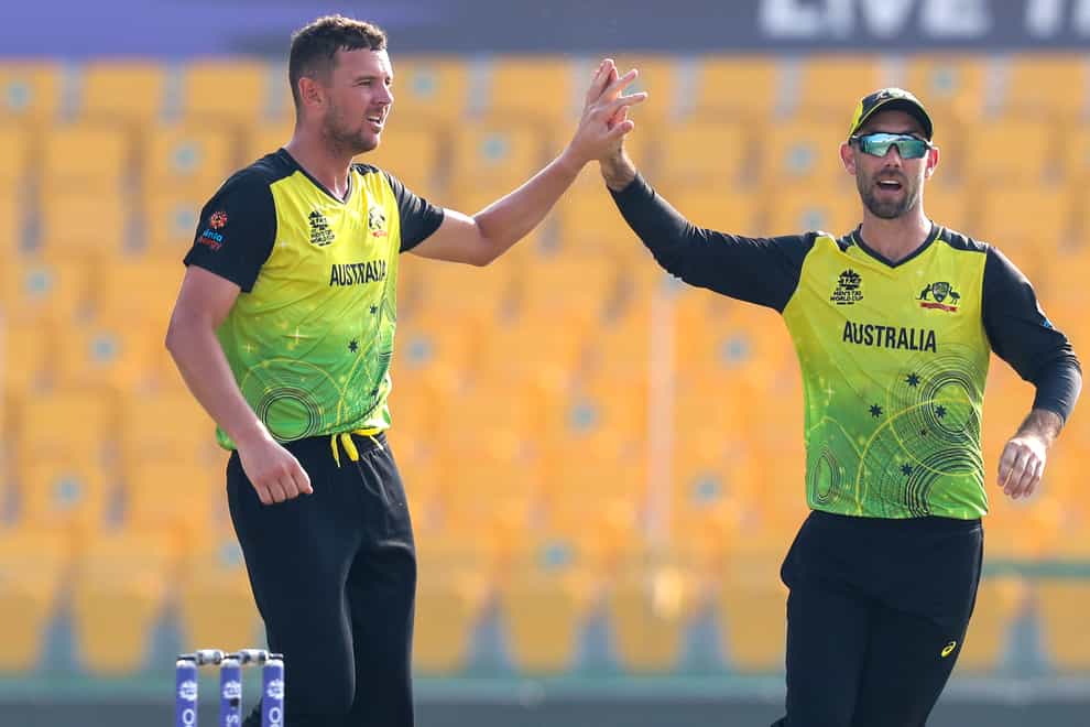 Josh Hazlewood (left) and Glenn Maxwell (right) celebrate the wicket of Shimron Hetmyer during their eight-wicket win over the West Indies at the T20 World Cup (Kamran Jebreili/AP)