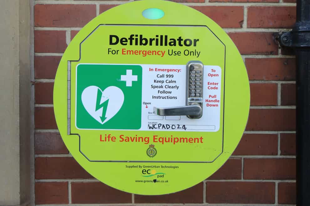 An emergency defibrillator on a wall in Garforth, Leeds (PA)