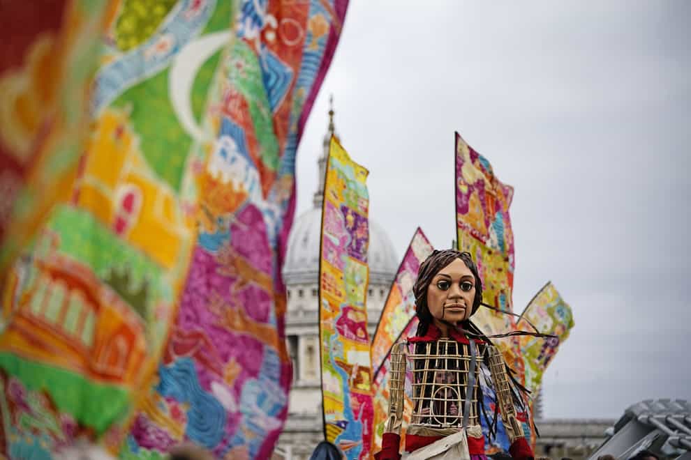 Little Amal, a 3.5-metre-tall puppet of a nine-year-old Syrian girl, has travelled through the country to Glasgow for Cop26 as a symbol for gender issues (PA)