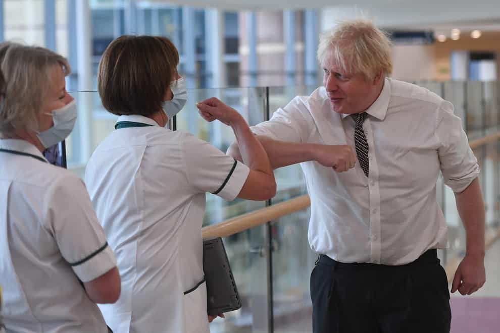 A maskless Boris Johnson meets medical staff during a visit to Hexham General Hospital (Peter Summers/PA)