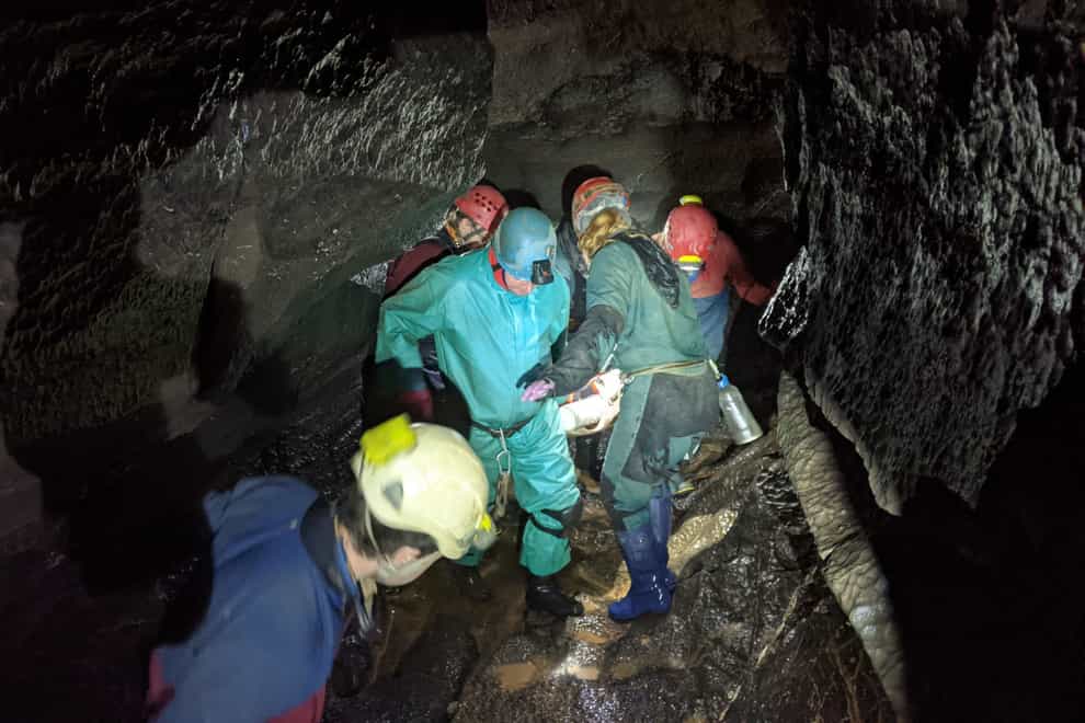 Members of South & Mid Wales Cave Rescue Team carrying the injured caver (South & Mid Wales Cave Rescue Team/PA)