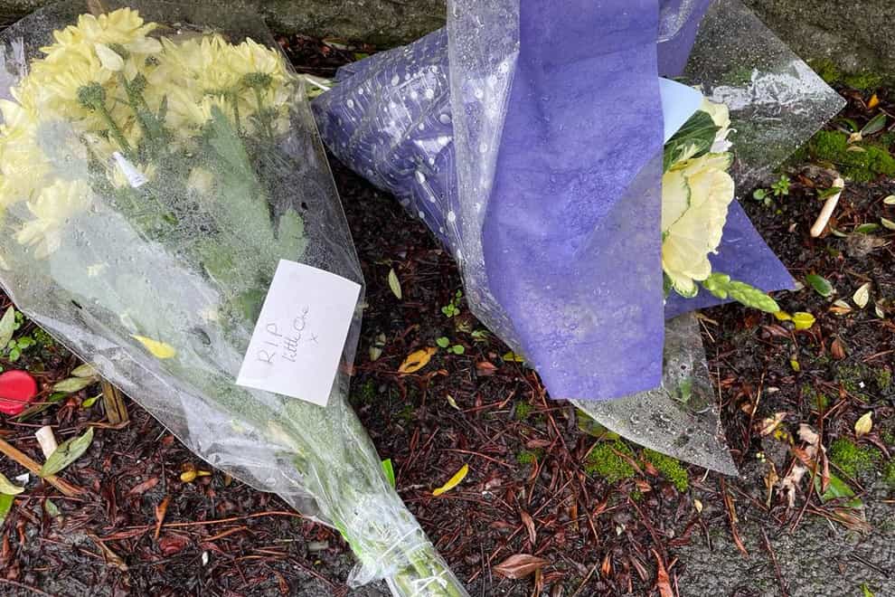 Flowers left outside house in Pentwyn, Caerphilly, where 10-year-old Jack Lis died after being mauled by dog (Bronwen Weatherby/PA)
